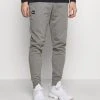 Under Armour RIVAL JOGGERS - Spodnie Treningowe - Pitch Gray Light Heather